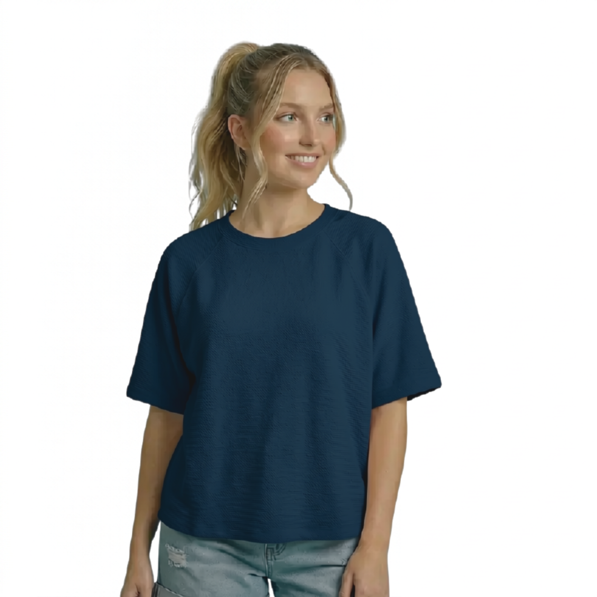 A person wearing a navy blue Cloudy Knit Short Sleeve Swing Top, featuring a short-sleeved, round neck design with a textured knit finish. Main image