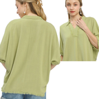A woman models the Umgee Linen Frayed Edge Short Sleeve Top in light green, featuring a collar, frayed edges, and fringe details—shown from both front and back views.