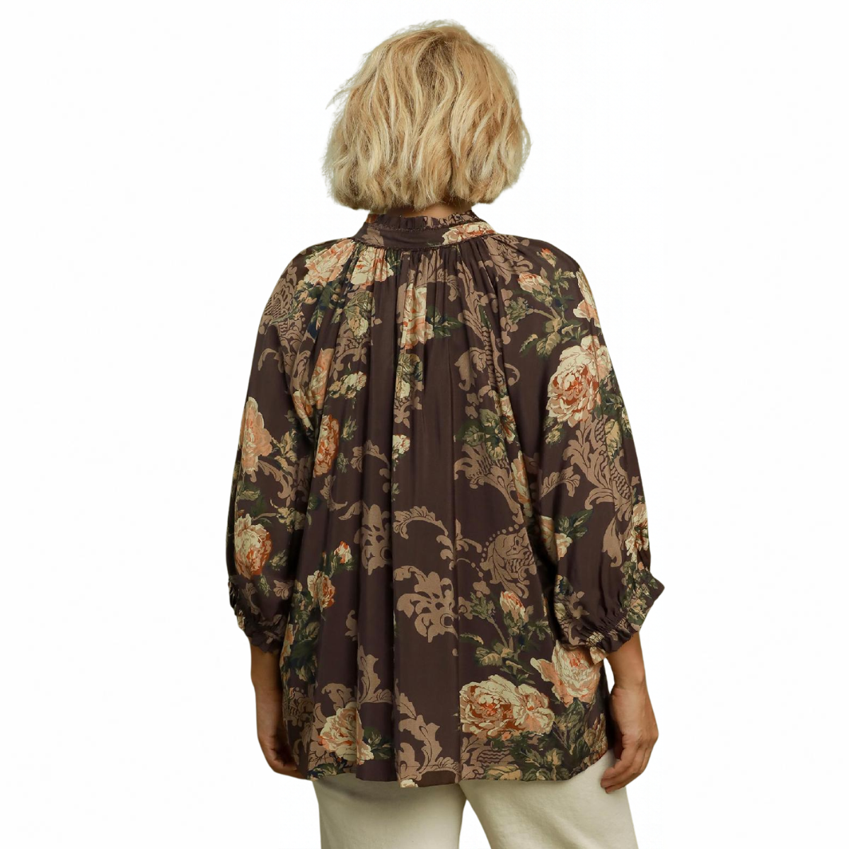 Back view of a person wearing a brown, floral-print Umgee Floral Ruffle Neck Split V-Neck Blouse with a ruffle collar, three-quarter length sleeves, and a split V-neck.