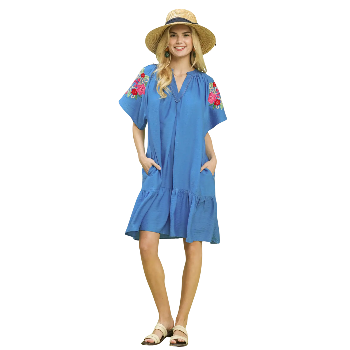 A woman stands smiling in an Umgee Embroidered Sleeve Dress, paired with a straw hat and sandals. Main image