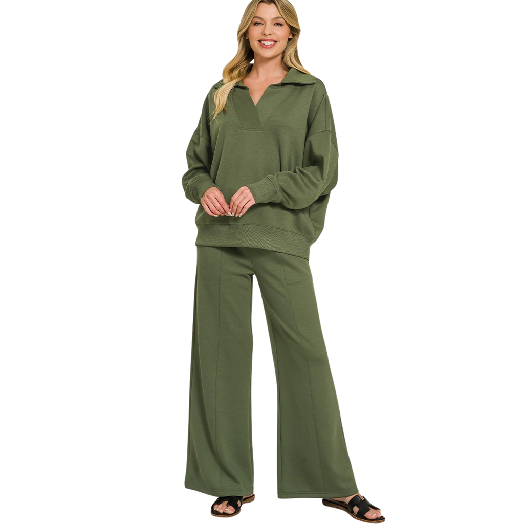 A woman wears an olive green FASHION GO Scuba Collared Pullover and Pants Set featuring a pullover with a collar, drop shoulders, and matching center-seam, wide-leg trousers.