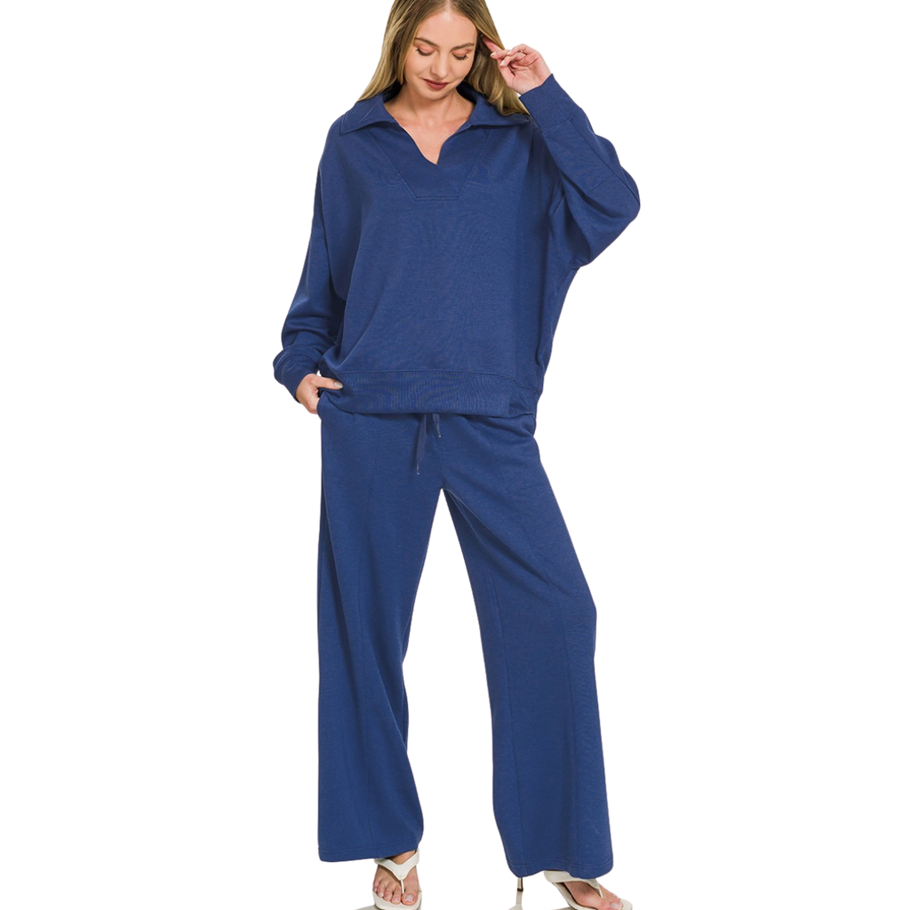A woman wearing a dark blue FASHION GO Scuba Collared Pullover and Pants Set featuring a collared pullover and wide-leg trousers with a center seam.