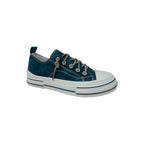 Displayed on a plain white background is the Aman Navy Tooled Sneaker by VERY G, featuring a navy upper with white toe cap, thick white sole, and sparkling rhinestone shoelaces. This Western-inspired sneaker is adorned with subtle tooled floral detailing for added charm.