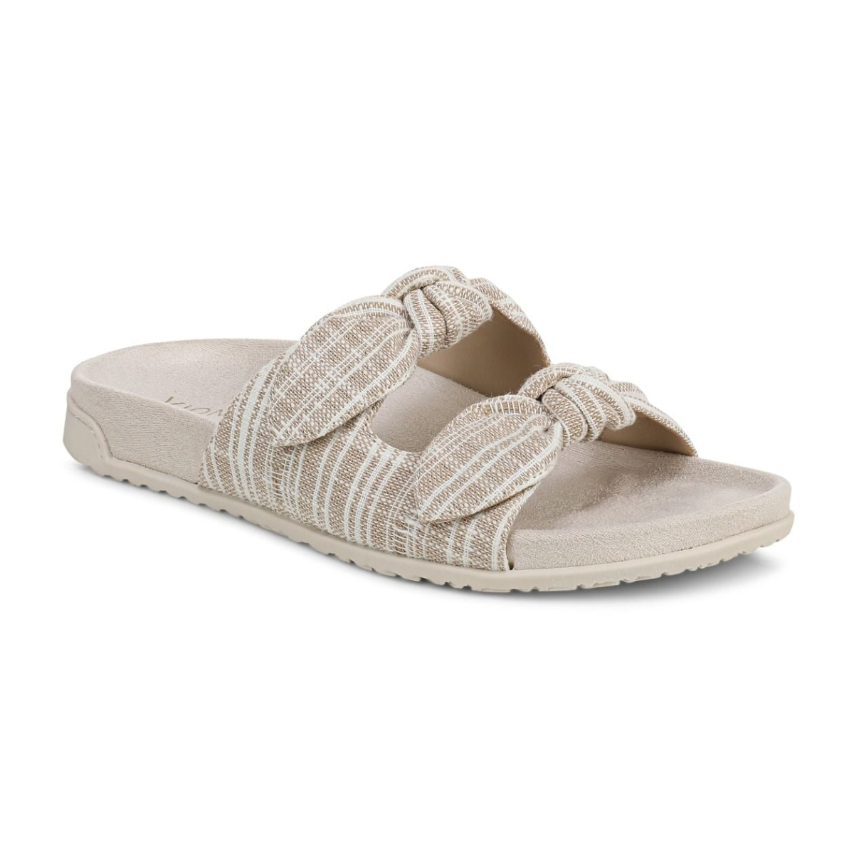 The Vionic Elara Adjustable Slide Sandal features two wide, textured beige fabric straps with knot details and a contoured supportive sole for comfort. Main image