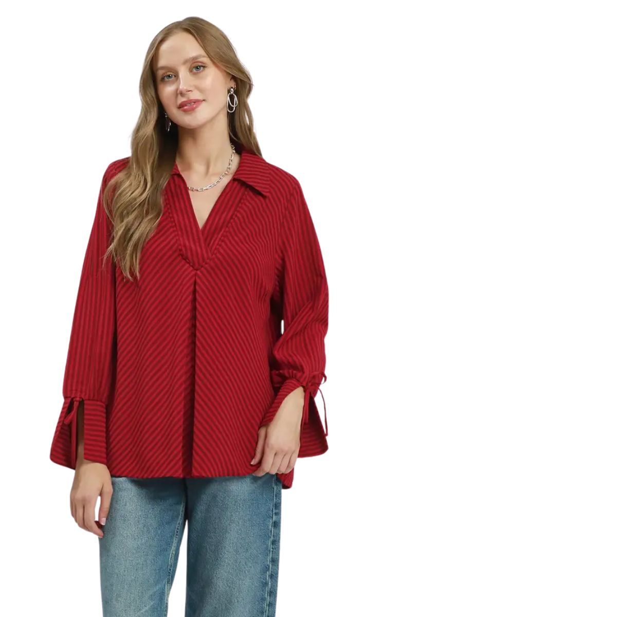 A woman wearing the Umgee Striped V-Neck Collared Blouse in Deep Red/Crimson paired with blue jeans, standing against a white background.