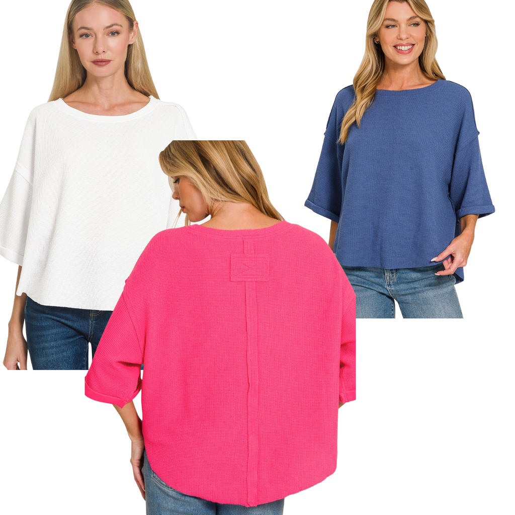 Three women wear Zenana Double Knit Exposed Seam Curved Hem Tops in white, blue, and pink with blue jeans. The loose-fit tops have short sleeves and are shown from both front and back.