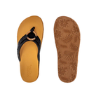 The FLOJOS Viernes Flip Flop is a women's sandal with tan soles, black faux leather straps, and a circular buckle. It features a memory foam footbed, floral-patterned sole for comfort and style, plus the distinctive FLOJOS branding.