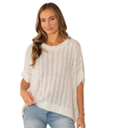 A woman wears the Sew In Love Relaxed Fit Dolman Sleeves Open Knit Top in white with light blue jeans, standing with one hand in her pocket against a white background.