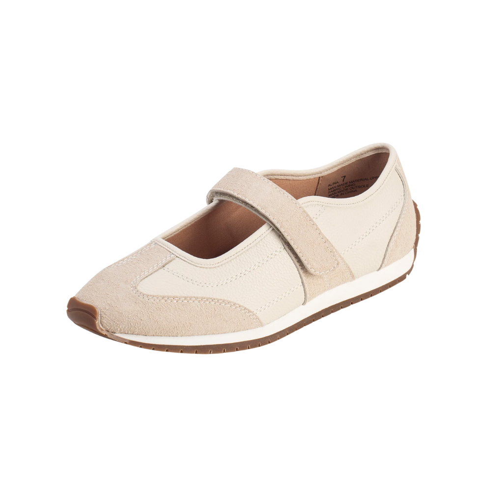 The Yellow Box Alina MaryJane Sneaker is a beige women’s shoe featuring a Velcro strap, suede accents, and a brown rubber sole that provides cushioned comfort and vintage style. Shown on a white background.