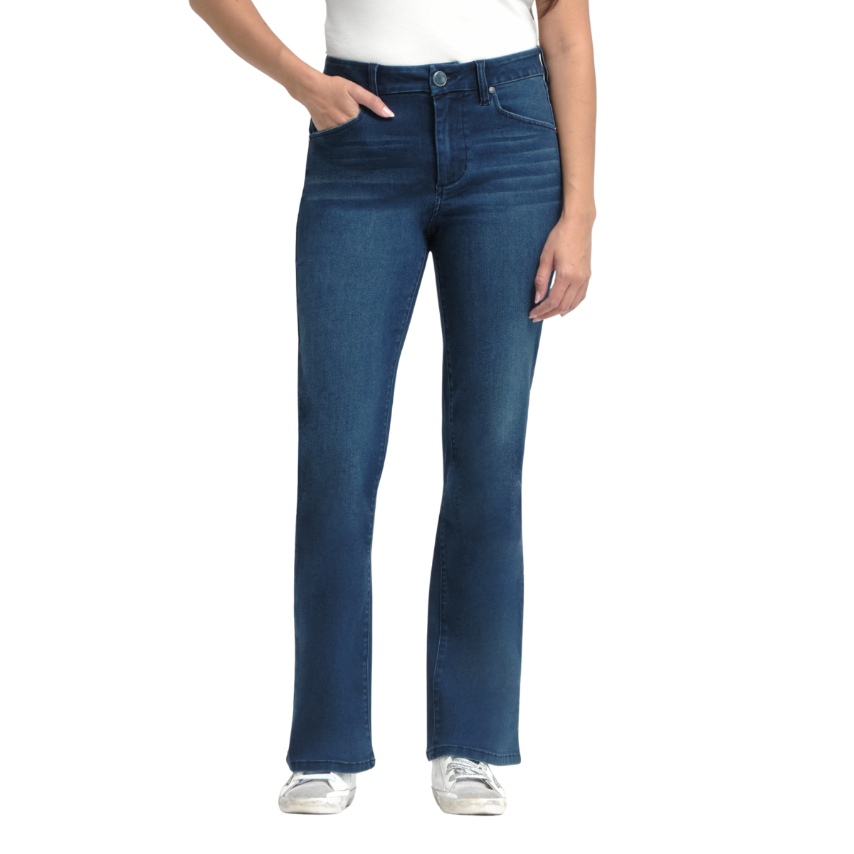 A person wears FASHION GO’s 30'' Better Butter Slim Boot Jean in Belle, paired with a white top and sneakers, one hand in a pocket, standing against a white background. Main image