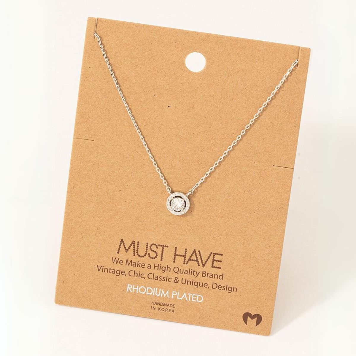 A Gold Dipped Cubic Zirconia Halo Pendant Necklace on a cardboard display card labeled "FASHION GO," noting it is rhodium plated, handmade in Korea, and marketed as vintage, chic, classic, and unique.