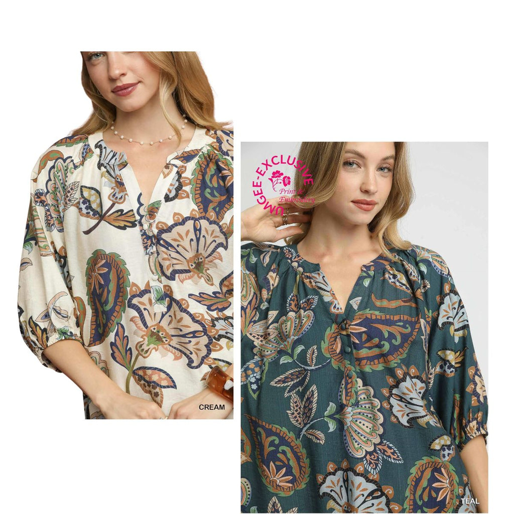 Two women model the Umgee Boho Paisley Puff Sleeve Blouse in two different colors—cream and teal—each showcasing a split neckline and three-quarter puff sleeves.