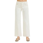 A person wearing Fashiongo Tummy Control Mid Rise Ankle Straight Raw Hew Pants in white with beige flats. The photo is cropped from midriff to feet.