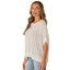 A woman smiles with her hair down, wearing the Sew In Love Relaxed Fit Dolman Sleeves Open Knit Top in white and light blue ripped jeans against a white background.