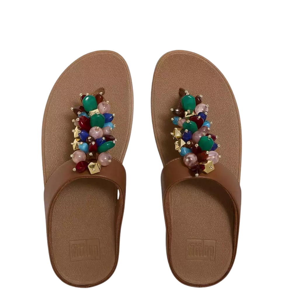 The Fino Bead Toe-Post Sandal by Fit Flop in Terracotta from FITFLOP USA LLC features cushioned Microwobbleboard midsoles and multicolored beaded embellishments on the straps.