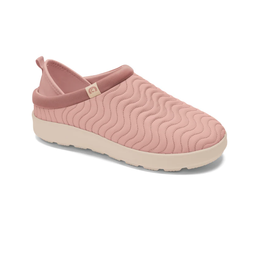 The COBIAN Nami Flip Slips are closed-toe slip-on shoes in pink, featuring a quilted wave pattern, a thick off-white EVA cupsole, and a convenient pull tab at the heel for comfortable wear.