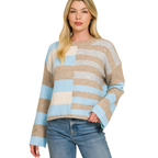 A woman models the FASHION GO Lightweight Wool Blend Color Block Sweater, featuring long sleeves and beige, blue, and cream stripes, styled with blue jeans—an ideal addition to your fall wardrobe.