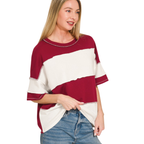 A woman wears the Zenana French Terry Color Block Top—a casual, short-sleeve, oversized red and white wide stripe t-shirt—paired with blue jeans against a white background.