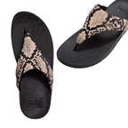 The FITFLOP USA LLC Lulu Snake Print Flip Flop features beige and black snakeskin-patterned straps and a comfortable Microwobbleboard midsole, shown from top and angled side views.