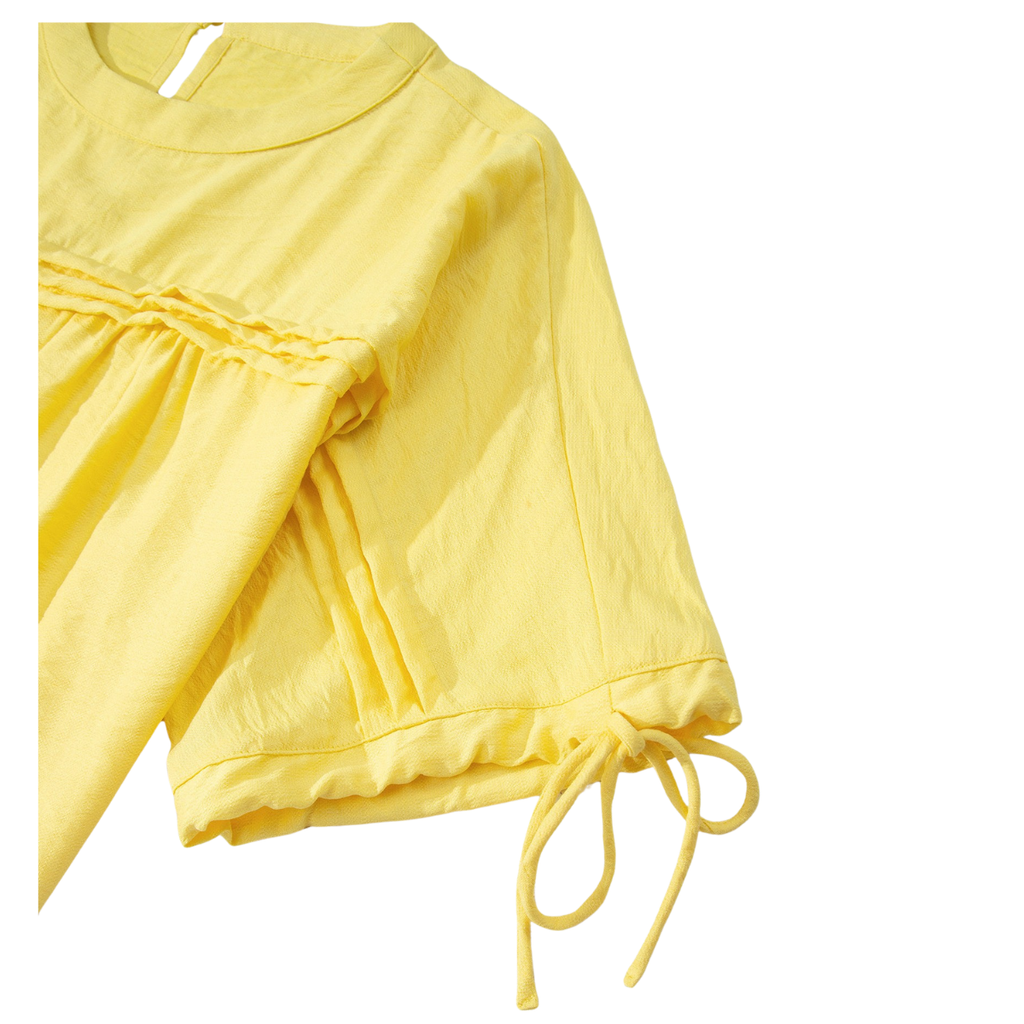 The Tie Half Sleeve Pleated Detail Babydoll Blouse by FASHION GO is a yellow top made from lightweight, breathable fabric, featuring short sleeves with gathered pleat detailing on the chest and ribbon ties at the sleeve ends, shown against a white background.