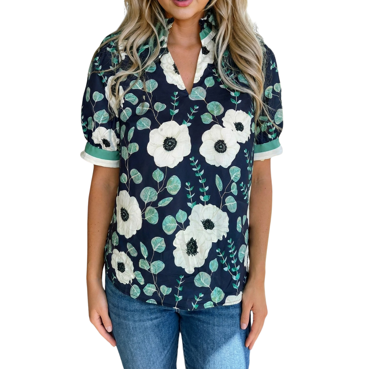 A woman wearing the FASHION GO Floral Print Blouse, featuring a navy blue color with large white floral prints and short sleeves, paired with blue jeans and standing against a white background.