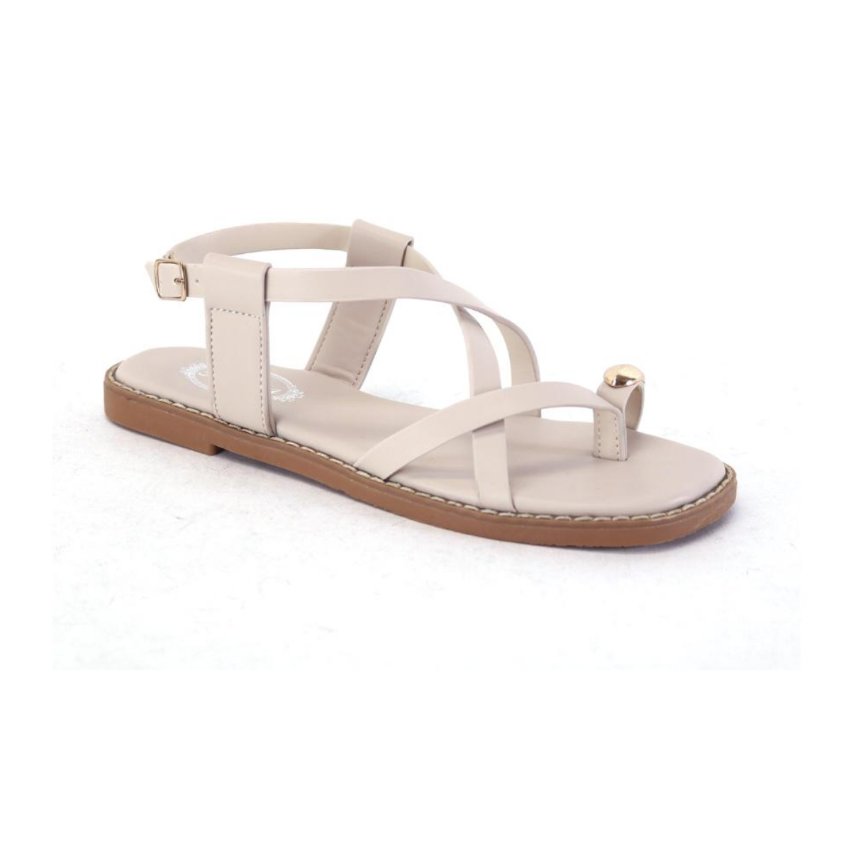 The SUMMER RIO Beige Flat Strappy Sandal with Gold Accent features crisscross straps, an ankle buckle, a chic gold toe detail, and toe loop—an elegant summer style shown on a white background. beige flat strappy sandal with gold toe accent and ankle strap by Atalina Main image
