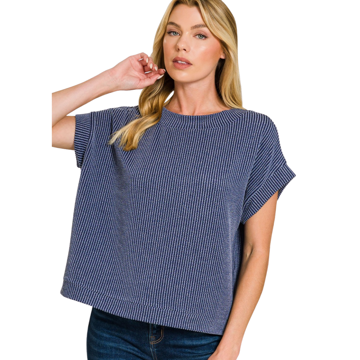 A woman in the Zenana Raised Rib Cap Sleeve Top, featuring a loose fit and boat neckline with blue stripes, paired with dark jeans, stands with one hand in her hair.