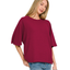 A woman models the Zenana Double Knit Short Sleeve Top in dark pink with blue jeans, standing against a white background.