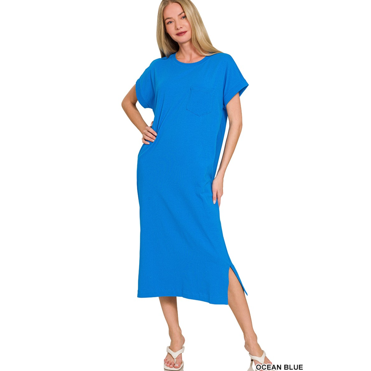 A woman wears the Zenana Round Neck Short Sleeve Midi T-Shirt Dress, featuring a chest pocket and side slit, standing against a white background.