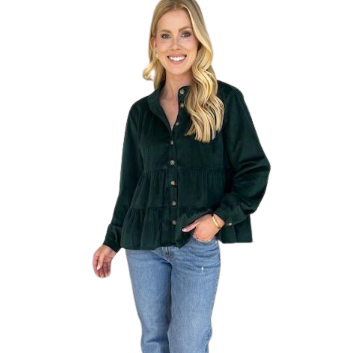A woman stands smiling with one hand in her pocket, wearing Carole Christian's Corduroy Tier Top—a dark green, buttery-soft long-sleeve blouse with ruffle detailing—paired with blue jeans.