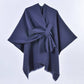 The ACCITY SIMPLE SOLID COLOR OBLIQUE STRAP CAPE SHAWL features a navy blue, asymmetrical design with wide sleeves and a side-tied belt, making it a stylish layering piece, shown on a plain white background.