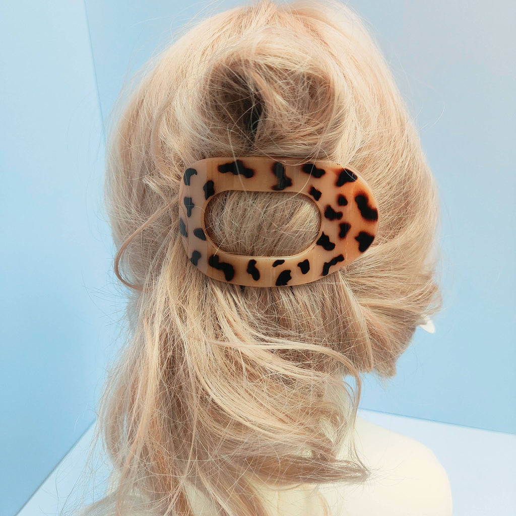 Blonde hair styled in a loose updo, secured with the ACCITY Oval Flat Hair Clip for Women, against a light blue background.