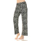 A person stands barefoot against a white background wearing Leggings Depot's Buttery Soft Print PJ Pants in a black leopard print, featuring a high rise and ultra-soft fabric.