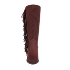 Front view of the Criss 2 Fringe Boot by Caleres—a tall, brown suede Western boot featuring fringe detailing along one side, a pointed toe, and a chunky block heel.