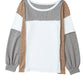 The Khaki Color Block Exposed Seam Long Sleeve Top from Shewin features a unique patchwork design with panels in light brown, white, and grey. It has a crew neck and cuffs at the wrists.