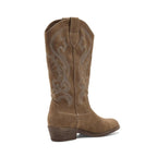 The Stutter Western Boot by Flipflops & Whatnots is shown in a left side profile view, crafted in brown suede with cowboy-inspired decorative stitching, a low stacked heel, and pull tabs at the top.