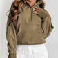 A woman with long wavy hair wears a Shewin gray zip-up stand collar ribbed thumbhole sleeve sweatshirt made of high-quality material and white shorts.