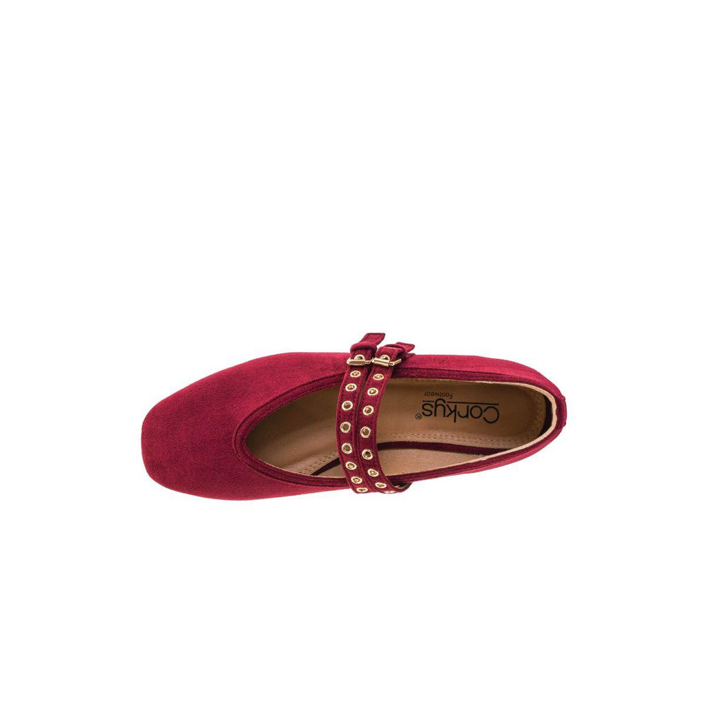 A top view of a single All Eyes on Me MaryJane Ballet Flat by CORKY’S FOOTWEAR INC in cranberry suede, featuring gold-studded double straps and a square toe, displayed on a plain white background.