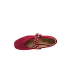 A top view of a single All Eyes on Me MaryJane Ballet Flat by CORKY’S FOOTWEAR INC in cranberry suede, featuring gold-studded double straps and a square toe, displayed on a plain white background.