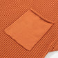 Close-up of the Shewin Patch Pocket Ribbed Knit Short Sleeve Sweater in orange, made from versatile ribbed fabric with a rectangular side pocket. Ideal for transitional weather.