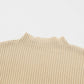 Close-up of the Shewin versatile Patch Pocket Ribbed Knit Short Sleeve Sweater in beige, featuring a mock neck and ideal for transitional weather, set against a white background.