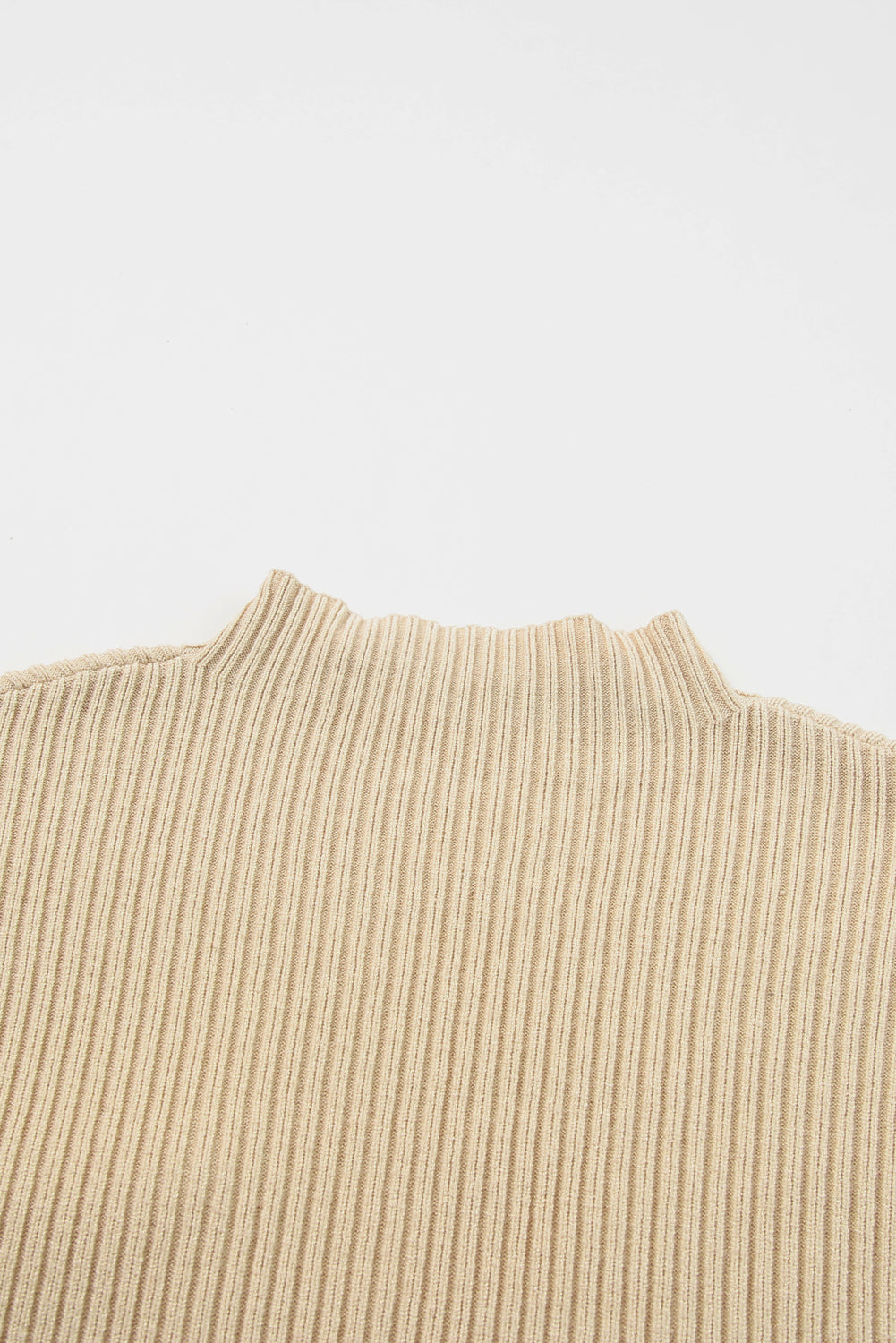 Close-up of the Shewin versatile Patch Pocket Ribbed Knit Short Sleeve Sweater in beige, featuring a mock neck and ideal for transitional weather, set against a white background.