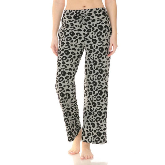 A person is wearing Leggings Depot Buttery Soft Print PJ Pants with a leopard pattern and drawstring waist, standing barefoot against a plain white background.