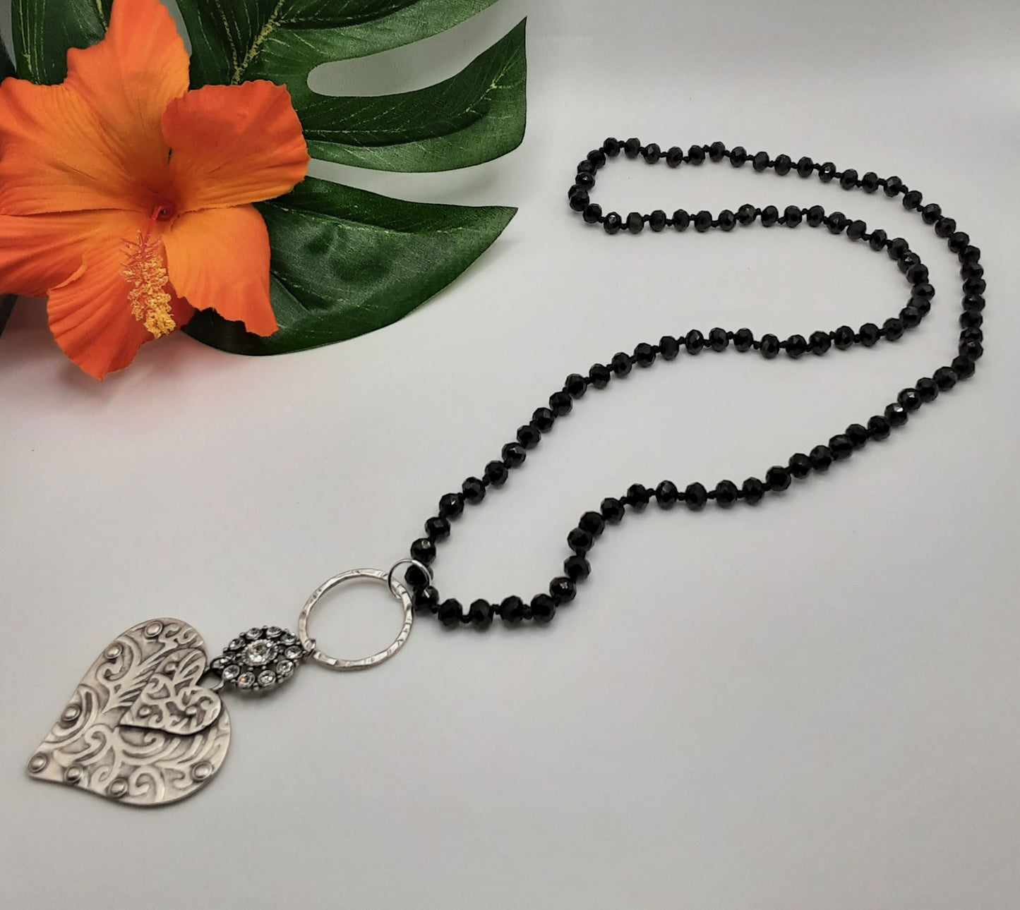 A Silver Heart Black Crystal Bead Handmade Necklace adorned with crystal beads and featuring a heart-shaped pendant, made by BFF CREATIONS.