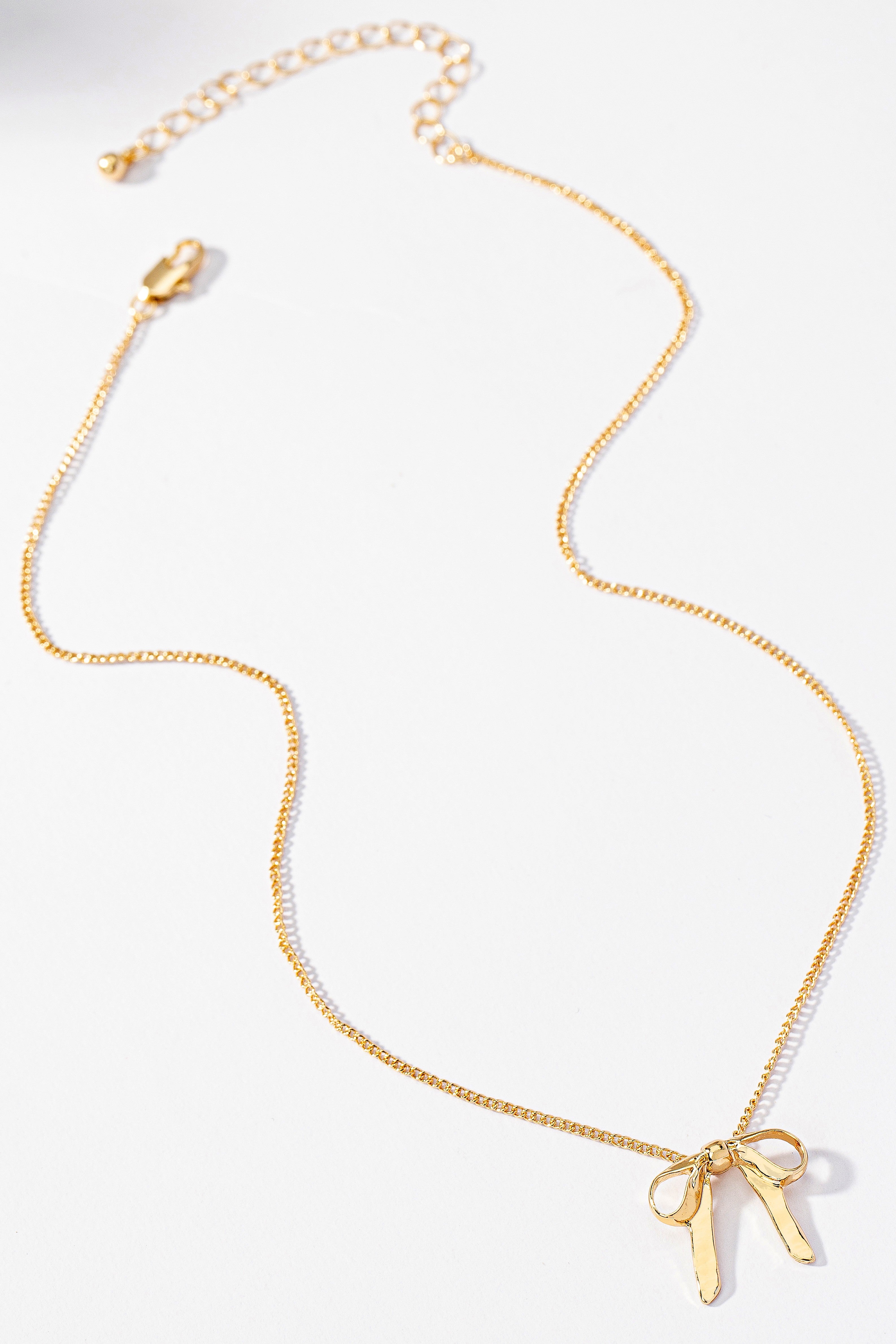 A gold Small Bow Pendant Necklace by FASHION GO on a white background. Main image