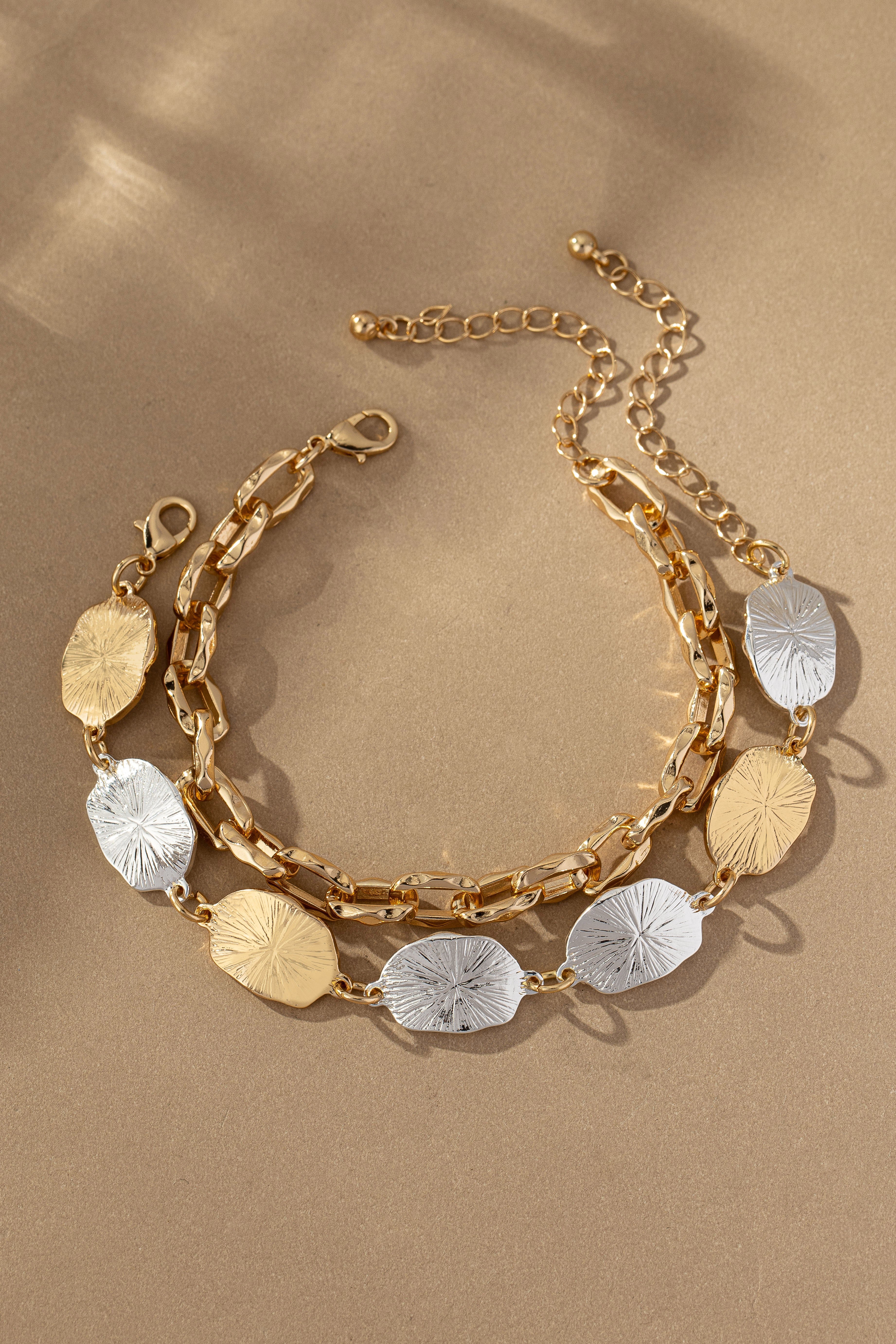 Two Bracelet Set by FASHION GO, displayed on a beige background with shadow play. Main image