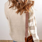 A person with wavy, light brown hair wears a Shewin Khaki Cable Knit Colorblock Crew Neck Drop Shoulder Sweater and blue jeans, carrying a brown bag with a striped strap over their shoulder.