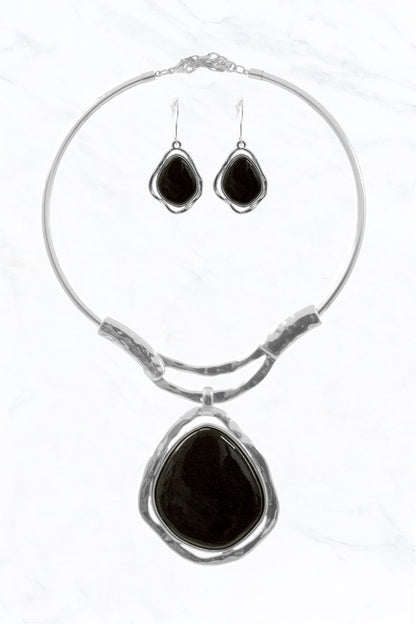 The Abstract Elegance Choker Set by FASHION GO pairs a silver choker and drop earrings, each with large, irregular black stone pendants for a striking modern look against a white background.