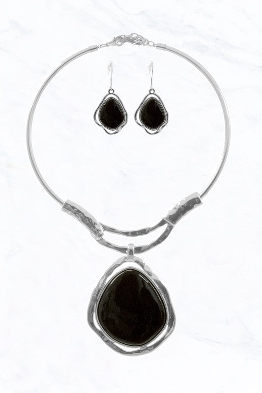 The Abstract Elegance Choker Set by FASHION GO pairs a silver choker and drop earrings, each with large, irregular black stone pendants for a striking modern look against a white background.