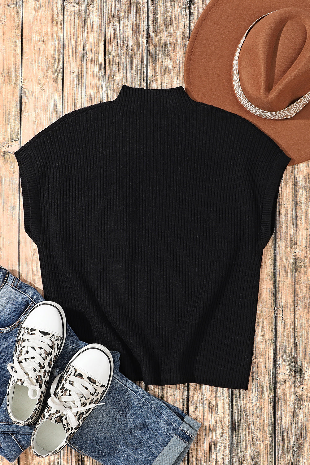 A Pink Patch Pocket Ribbed Knit Short Sleeve Sweater from Shewin is displayed on a wooden surface with jeans, leopard print sneakers, and a brown hat—ideal for transitional weather.